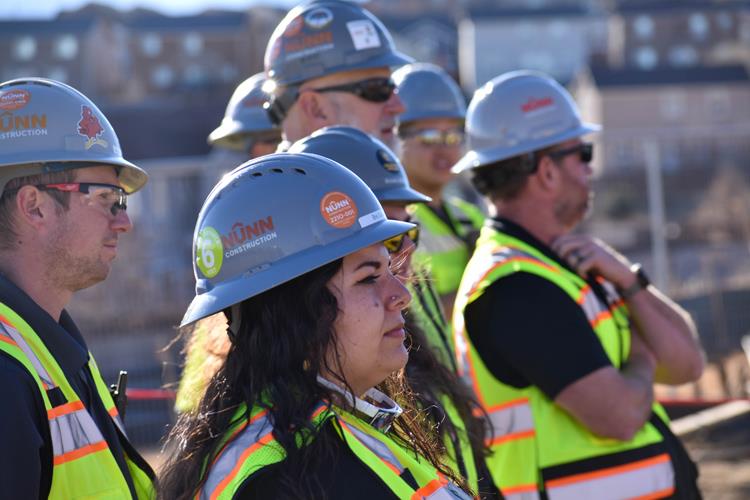 Group of people in hardhats at ceremony